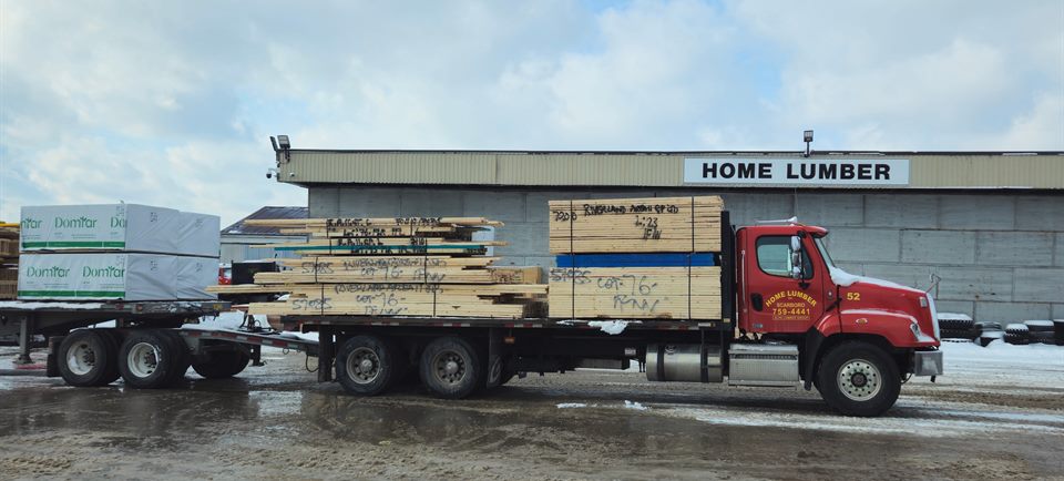 A loaded Home Lumber delivery truck outside the facility